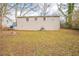 A backyard featuring an expanse of grass and trees, offering a private outdoor space at 3499 Villa Se Cir, Atlanta, GA 30354