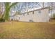 View of backyard featuring the building's exterior and a grassy lawn with trees at 3499 Villa Se Cir, Atlanta, GA 30354