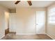Neutral bedroom with a ceiling fan, carpet floors, one window, and two doors at 3499 Villa Se Cir, Atlanta, GA 30354