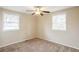 Neutral bedroom with carpet, ceiling fan, two windows, and ample closet space at 3499 Villa Se Cir, Atlanta, GA 30354