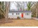Charming single-story home with a bright orange front door and neutral color scheme at 3499 Villa Se Cir, Atlanta, GA 30354