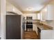 Modern kitchen featuring stainless steel appliances, granite countertops, and white cabinetry at 3499 Villa Se Cir, Atlanta, GA 30354