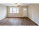 Open living room with wood flooring, ceiling fan and natural light from the front door and window at 3499 Villa Se Cir, Atlanta, GA 30354