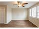 Spacious living room with modern ceiling fan, wood flooring, and ample natural light through the windows at 3499 Villa Se Cir, Atlanta, GA 30354