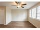 Spacious living room with modern ceiling fan, wood flooring, and ample natural light through the windows at 3499 Villa Se Cir, Atlanta, GA 30354