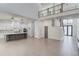 Sunlit open living space with kitchen, dining area, staircase, and modern fixtures highlighting contemporary design at 734 Riverside Rd, Sugar Hill, GA 30518