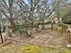 Backyard deck with space for outdoor seating and mature trees at 96 Sir Scott Ct, Lawrenceville, GA 30044