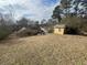 Large backyard featuring mature trees, storage shed, and patio, offering an outdoor retreat at 96 Sir Scott Ct, Lawrenceville, GA 30044