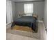 Cozy bedroom featuring tiled floors, a comfortable bed, and natural light at 96 Sir Scott Ct, Lawrenceville, GA 30044