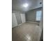Bright bedroom with tiled floors, a window, and double closets providing ample storage at 96 Sir Scott Ct, Lawrenceville, GA 30044