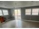 Open-concept living room with large windows, a sliding door to the exterior and tiled flooring at 96 Sir Scott Ct, Lawrenceville, GA 30044