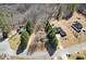 An aerial view showcasing the home and its spacious lot with mature trees and nearby homes at 255 N Loblolly Xing, Temple, GA 30179