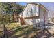 Suburban home showcasing a backyard with a wooden deck, staircase, and a chain-linked fence at 255 N Loblolly Xing, Temple, GA 30179