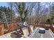 Outdoor deck featuring a grill, table with chairs, and lush green trees at 255 N Loblolly Xing, Temple, GA 30179