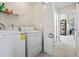 Functional laundry room with modern washer and dryer appliances with bright light at 255 N Loblolly Xing, Temple, GA 30179