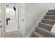 View of the carpeted stairway leading to the lower level with tiled rec room at 255 N Loblolly Xing, Temple, GA 30179