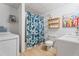 Basement bathroom and laundry area with floral shower curtain and washer at 4550 Wenden Ln, Marietta, GA 30062