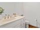 Half bathroom with a white vanity, silver fixtures, and hardwood floors at 4550 Wenden Ln, Marietta, GA 30062