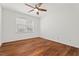 Bright bedroom with hardwood floors, ceiling fan, and window with blinds at 4550 Wenden Ln, Marietta, GA 30062