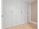 Built-in closet with white doors, gold handles, and tiled floors at 4550 Wenden Ln, Marietta, GA 30062