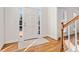 Bright home foyer featuring a white door with sidelights and hardwood flooring at 4550 Wenden Ln, Marietta, GA 30062