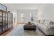 Bright living room with hardwood floors, an area rug and stylish ottoman at 4550 Wenden Ln, Marietta, GA 30062