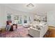 Spacious living room with a crystal chandelier, and a large, bright bay window at 4550 Wenden Ln, Marietta, GA 30062