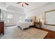 Main bedroom featuring a tray ceiling, carpet floors, and natural lighting at 4550 Wenden Ln, Marietta, GA 30062