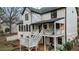 Backyard showcasing a two-story home with a white deck, stairs, and outdoor fitness area at 559 Fairway Dr, Woodstock, GA 30189