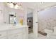 Bright bathroom featuring a white vanity, decorative shower curtain, and a glimpse into the bedroom at 559 Fairway Dr, Woodstock, GA 30189