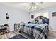 Cozy bedroom with a blue plaid comforter, decorative pillows, and natural light from the window at 559 Fairway Dr, Woodstock, GA 30189