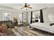 Bedroom featuring wood-look floors, a ceiling fan, and a fitness area with a weightlifting bench at 559 Fairway Dr, Woodstock, GA 30189