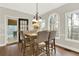 Dining area with wooded views, neutral colors, and a sliding door leading outside at 559 Fairway Dr, Woodstock, GA 30189