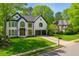 Traditional two-story home with black shutters, symmetrical windows, gabled roof, and mature landscaping at 559 Fairway Dr, Woodstock, GA 30189