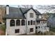 Rear view of a two-story home with a covered porch, white siding, and a dark roof at 559 Fairway Dr, Woodstock, GA 30189