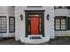 Close-up of a vibrant red front door with sidelights and decorative hardware, welcoming guests at 559 Fairway Dr, Woodstock, GA 30189