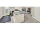 Spacious kitchen island with a sink, gray countertops, and a view into the adjacent living area at 559 Fairway Dr, Woodstock, GA 30189