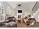 Cozy living room featuring a fireplace, built-in shelving, and large windows with natural light at 559 Fairway Dr, Woodstock, GA 30189