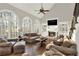 Bright living room with hardwood floors, fireplace, built-in shelving and large arched windows at 559 Fairway Dr, Woodstock, GA 30189