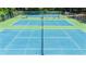 Outdoor tennis courts showcase well-maintained blue and green playing surfaces at 559 Fairway Dr, Woodstock, GA 30189