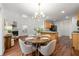 Open dining area with wood floors, stylish chandelier, and plenty of natural light at 5935 Mountain Top Pl, Cumming, GA 30041