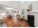 Bright living room featuring hardwood floors, a fireplace, and modern furnishings at 5935 Mountain Top Pl, Cumming, GA 30041