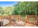 Elevated view from the home's deck overlooking the serene and private backyard and lush green trees at 1048 Brookdale Dr, East Point, GA 30344