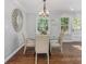 Well-lit dining room with a modern chandelier and circular wall decor at 1048 Brookdale Dr, East Point, GA 30344