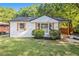 Charming home with a fresh white paint job, black roof, and wood shutters at 1048 Brookdale Dr, East Point, GA 30344