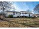 Backyard featuring the home, a sunroom, and grass at 202 Porter Ln, Jonesboro, GA 30236