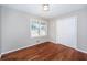 Bright bedroom featuring hardwood floors, a window with natural light, and a closet at 202 Porter Ln, Jonesboro, GA 30236