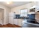 Cozy kitchen featuring white cabinets, stainless appliances, and attractive blue backsplash at 202 Porter Ln, Jonesboro, GA 30236