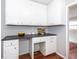 Kitchen featuring ample white cabinetry, dark countertops, and hardwood floors at 202 Porter Ln, Jonesboro, GA 30236