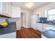 Cozy kitchen featuring white cabinets, dark countertops, and modern backsplash at 202 Porter Ln, Jonesboro, GA 30236